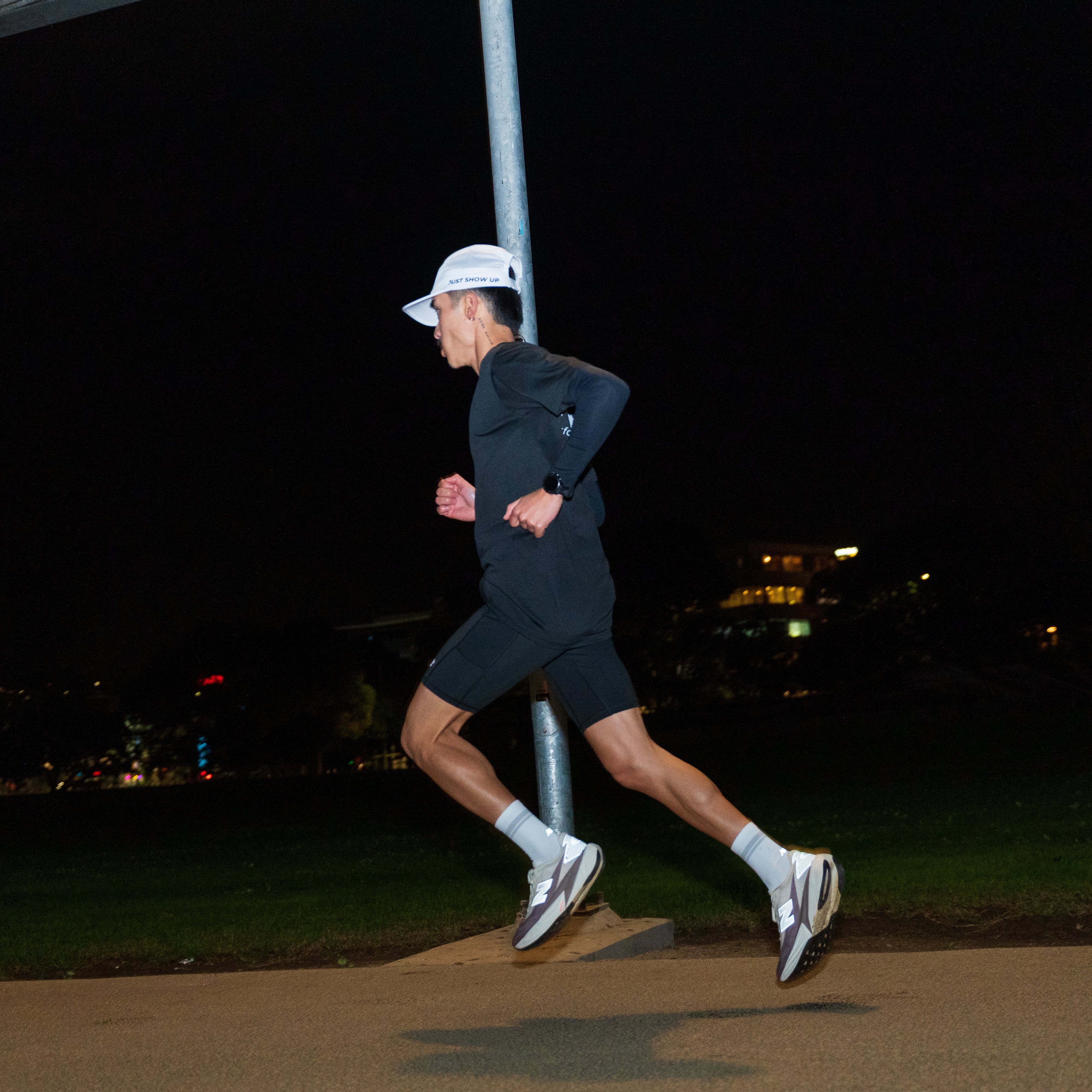 Person running at night on with white running cap